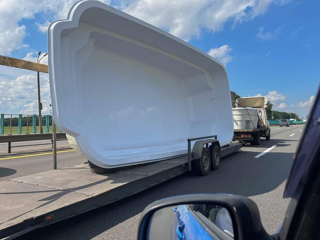transportation delivery of the pool on a car trailer.