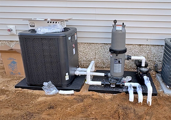 Electric heat pump pool heater being installed by Pool Brokers USA