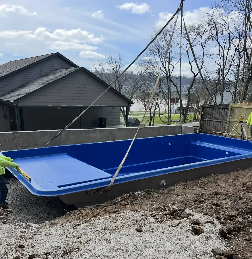 fiberglass pool installation in tight yard with crane